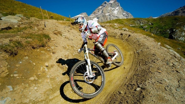 Mountain bike in Val d'Aosta district, below Cervino Mountain